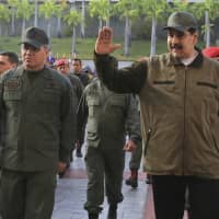 Venezuelan President Nicolas Maduro, accompanied by Defense Minister Vladimir Padrino Lopez, arrives at Fort Tiuna in Caracas on Thursday. | AP