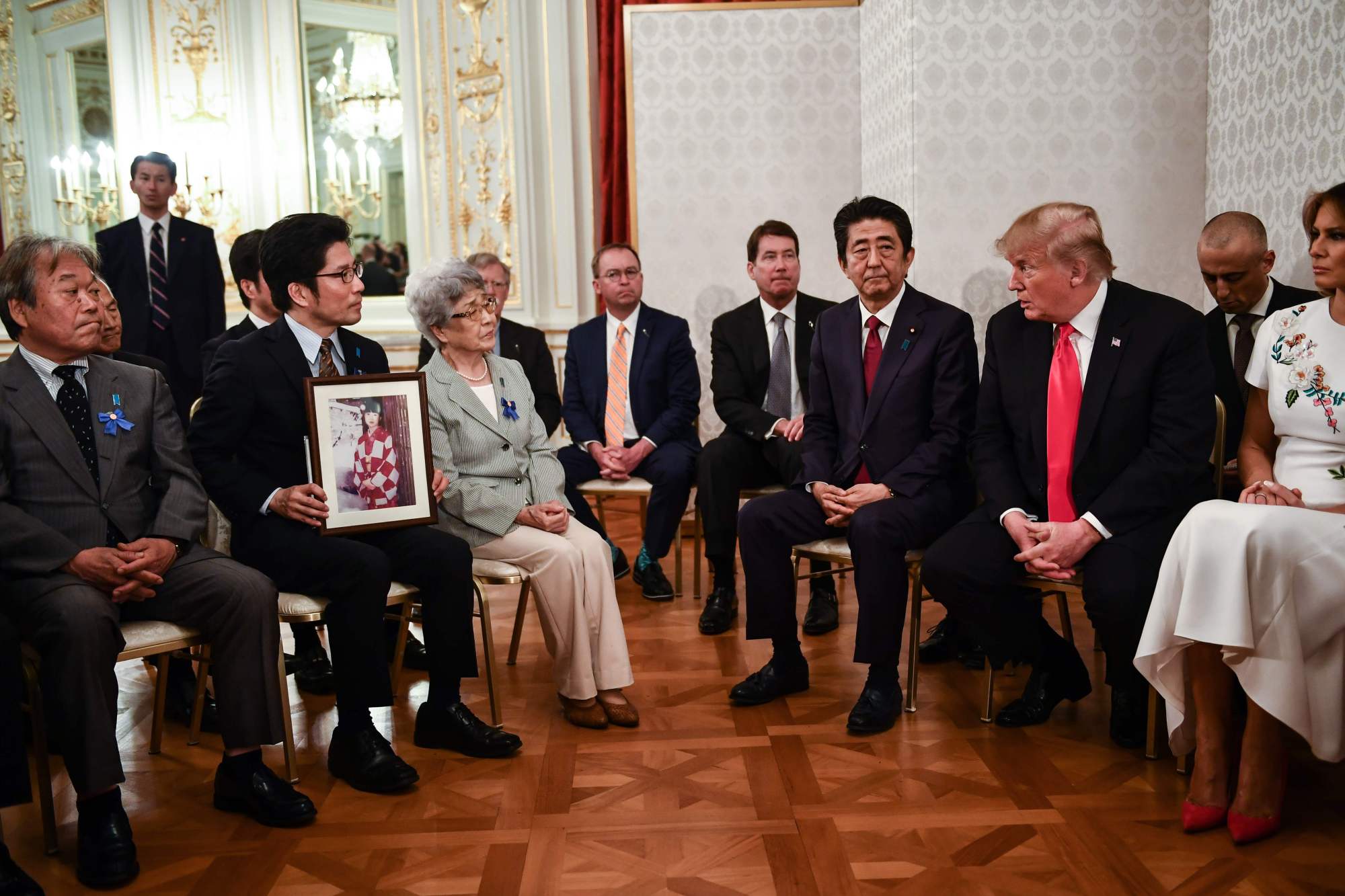 During a meeting in Tokyo on Monday, U.S. President Donald Trump speaks to the relatives of Japanese nationals abducted by North Korea decades ago as first lady Melania Trump and Prime Minister Shinzo Abe look on. | AFP-JIJI