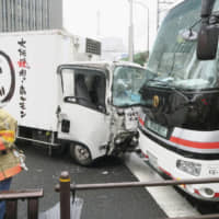 A truck that rammed into three pedestrians and hit four vehicles is seen at the site of the crash in Tokyo\'s Shinbashi district on Tuesday. | KYODO