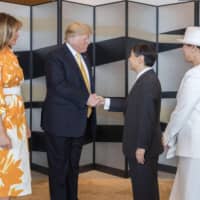 Emperor Naruhito shakes hands with U.S. President Donald Trump as he bids him farewell Tuesday at a hotel in Tokyo while Melania Trump and Empress Masako look on. | IMPERIAL HOUSEHOLD AGENCY / VIA KYODO