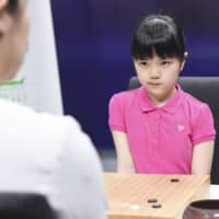 Sumire Nakamura, 10, Japan\'s youngest professional go player, faces 27-year-old Wang Chenxing during her first international match Tuesday in Beijing. | KYODO