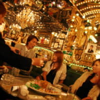 Female customers enjoy chatting and having drinks with male hosts at a Tokyo host club. | GETTY IMAGES / VIA KYODO