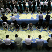 Electoral officials count ballots for the general election at the city office in Himeji, Hyogo Prefecture, in October 2017. | BLOOMBERG