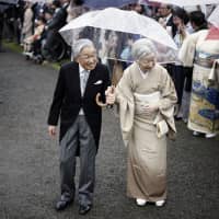 Emperor Akihito and Empress Michiko greet guests during the autumn garden party at the imperial garden within the Akasaka Estate in Tokyo in November. | AP