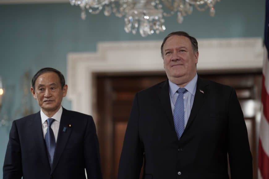Chief Cabinet Secretary Yoshihide Suga arrives with U.S. State Secretary Mike Pompeo on May 9 at the State Department in Washington. | AP