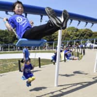 This photo, taken in Hibikinada Green Park in Kitakyushu on Saturday, shows a circular swing measuring about 163 meters in circumference. A total of 100 swings are attached to the structure. It has been recognized by Guinness World Records as the world\'s biggest. | KYODO