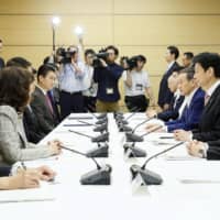 A meeting is held at the Prime Minister\'s Office in Tokyo on Friday to discuss measures to tackle human trafficking in Japan. | KYODO