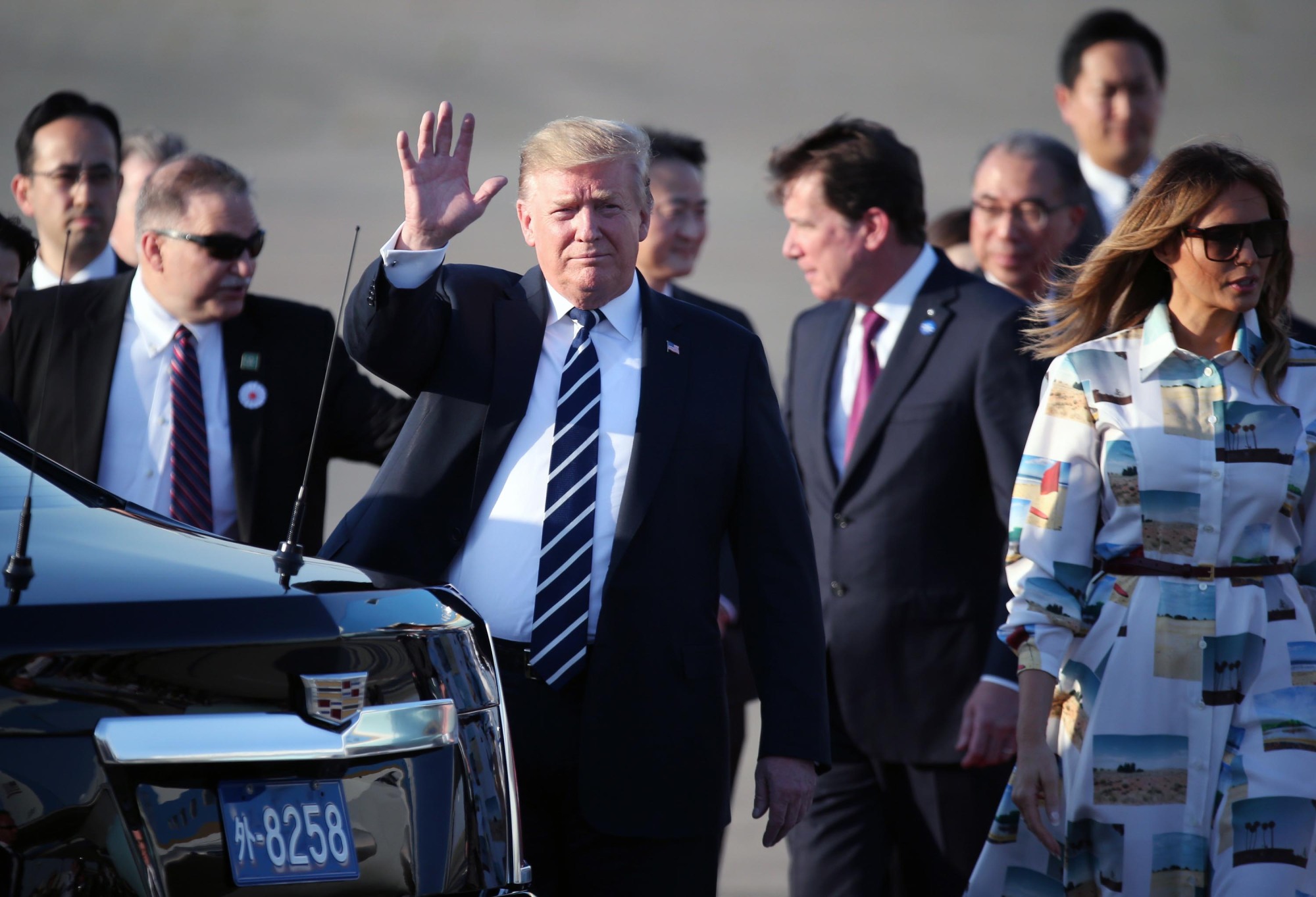U.S. President Donald Trump waves after arriving at Haneda airport in Tokyo on Saturday. | AP