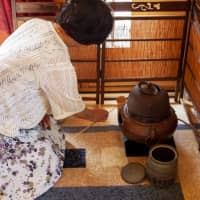 Keeping up traditions: Kumiko Imai-Duxfield prepares a tea ceremony at a teahouse she and her husband, Stephen, built in the backyard of her home and bed and breakfast in Sandspit, New Zealand. | TODD PACEY
