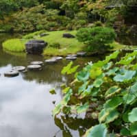 Mill stones are used as stepping stones in the stroll garden of Isuien in Nara. | STEPHEN MANSFIELD