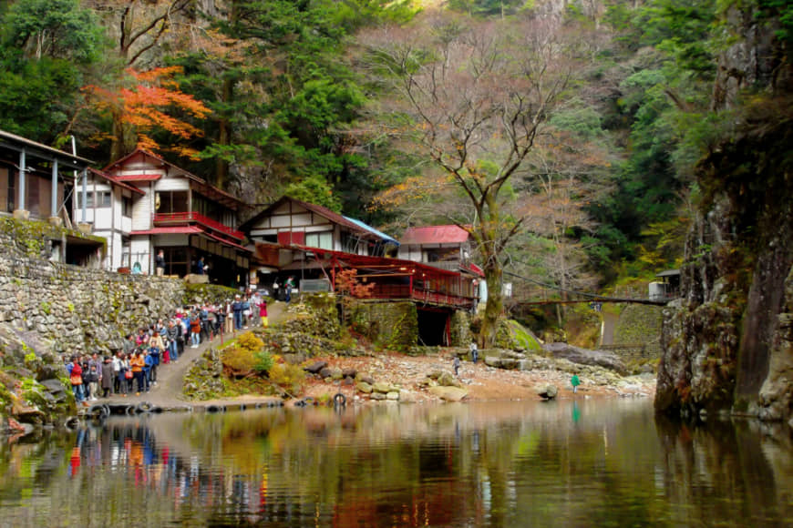Little outpost of civilization: Visitors wait just outside the rustic Kurofuchi-so teahouse, which sells freshly caught grilled ayu sweetfish. | ANGELES MARIN CABELLO