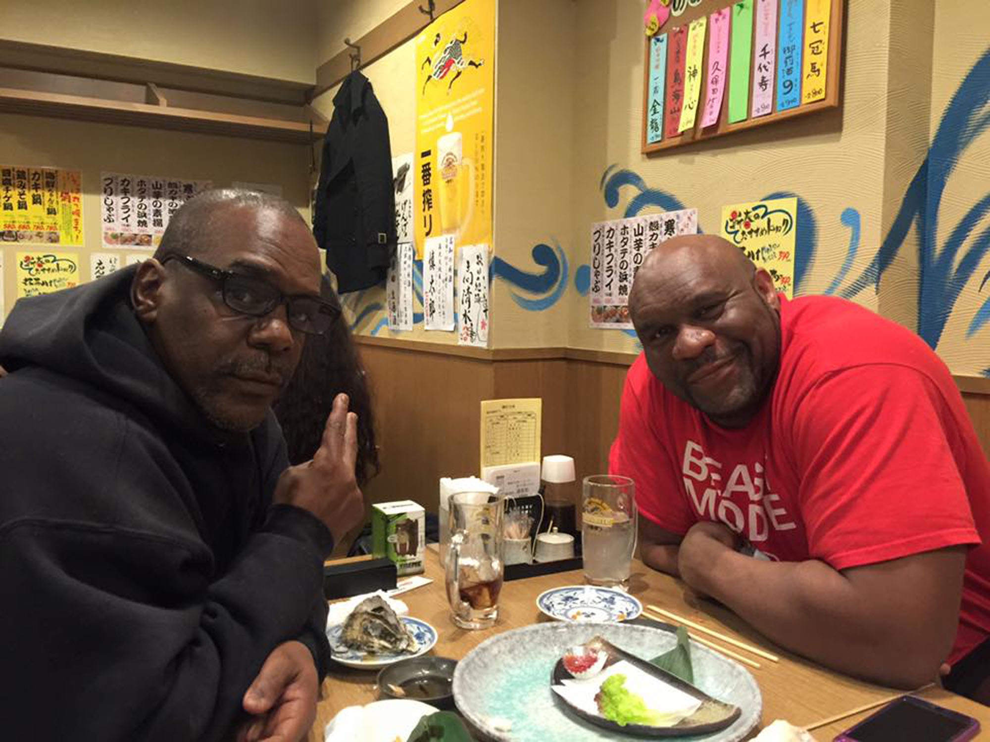 Out on the town: Writer Baye McNeil hits up an izakaya (Japanese pub) with kickboxer and media personality Bob Sapp. The pair discussed Sapp's 'Beast' persona, which has recently turned up in a series of commercials on YouTube. | PHOTO COURTESY OF BAYE MCNEIL