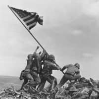 Take the hill: A Feb. 23, 1945, file photo shows U.S. Marines raising an American flag atop Mount Suribachi on the island of Ioto, aka Iwo Jima. | AP