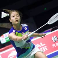 Nozomi Okuhara hits a return against Russia\'s Natalia Perminova during their women\'s singles match at the Sudirman Cup world badminton championships in Nanning, China, on Monday. | AFP-JIJI