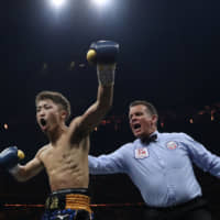 Naoya Inoue celebrates after defeating Emmanuel Rodriguez for the IBF world bantamweight title on Saturday in Glasgow, Scotland. | REUTERS