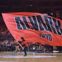 An Alvark cheerleader waves a giant flag during a time out on May 11 in Yokohama. | DAN ORLOWITZ