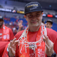 Alvark head coach Luka Pavicevic displays the net during his team\'s victory celebrations. | DAN ORLOWITZ