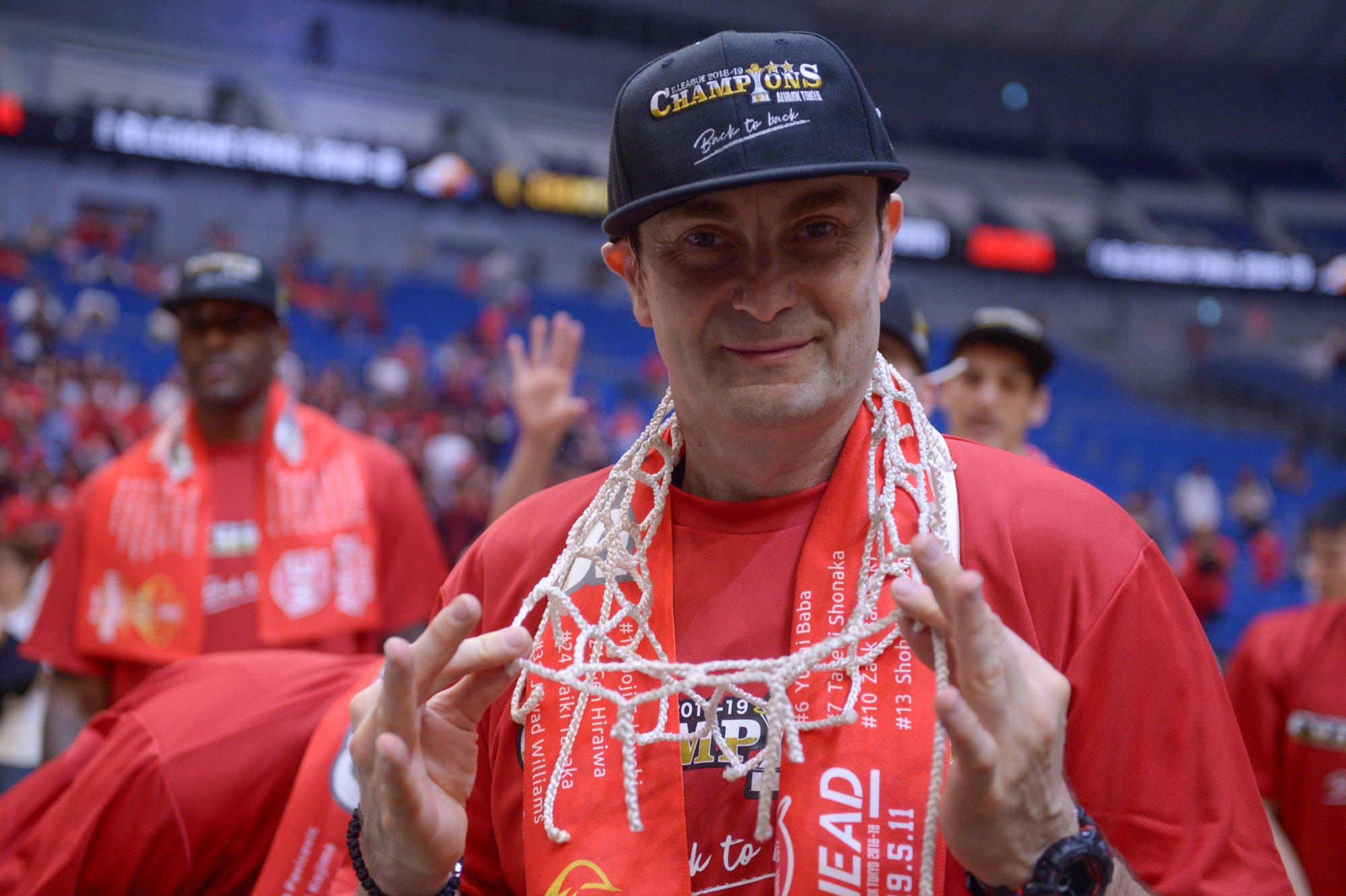 Alvark head coach Luka Pavicevic displays the net during his team's victory celebrations. | DAN ORLOWITZ