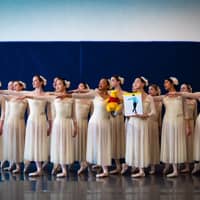 Members of the Crescendo Conservatory in Overland Park, Kansas, pose with a portrait of Yuzuru Hanyu and Winnie the Pooh during a recent rehearsal. | GAVIN DEYOUNG DANIELS