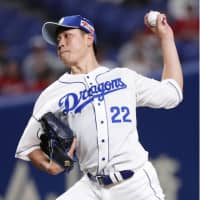 Dragons starter Yudai Ono fires a pitch in Tuesday\'s game against the Carp at Nagoya Dome. Ono fanned 13 batters in Nagoya\'s 6-0 victory over Hiroshima. | KYODO