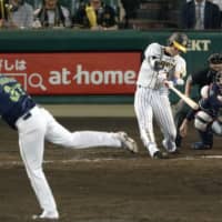 The Tigers\' Kento Itohara hits a game-winning single in the ninth inning against the Swallows at Koshien Stadium on Thursday night. Hanshin won 1-0. | KYODO