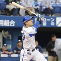 The BayStars\' Neftali Soto slugs a solo homer in the first inning on Friday against the Swallows at Yokohama Stadium. Yokohama defeated Tokyo Yakult 3-2. | KYODO