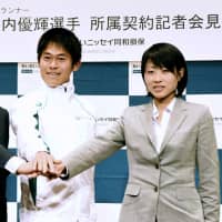 Yuki Kawauchi (left) and Yuko Mizuguchi pose during an event in Tokyo in April. The pair of runners, who are engaged, won the men\'s and women\'s titles, respectively, at the Vancouver Marathon on Sunday. | KYODO