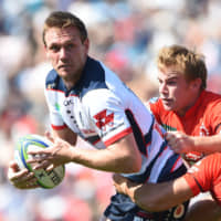 The Rebels\' Dane Haylett Petty is tackled by the Sunwolves in Super Rugby action on Saturday afternoon in Tokyo. | AFP-JIJI