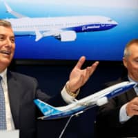 Boeing Commercial Airplanes CEO Kevin McAllister (left) and International Airlines Group CEO Willie Walsh attend the Boeing 737 Max 8 commercial announcement during the 53rd International Paris Air Show at Le Bourget Airport near Paris Tuesday. | REUTERS