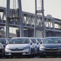 Cars ready to be exported are lined up at Yokohama port on May 23. | KYODO