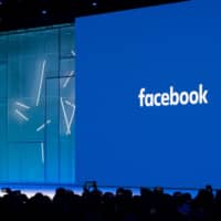 Facebook CEO Mark Zuckerberg speaks during the annual F8 summit at the San Jose McEnery Convention Center in San Jose, California, in May 2018. Facebook is leaping into the world of cryptocurrency with its own digital money, designed to let people save, send or spend money as easily as firing off text messages. | AFP-JIJI
