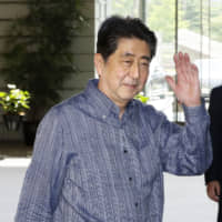 Prime Minister Shinzo Abe arrives at his office in Tokyo on Tuesday. | KYODO