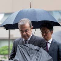 Former Nissan Motor Chairman Carlos Ghosn arrives for a pre-trial hearing at the Tokyo District Court on Monday. | AFP-JIJI