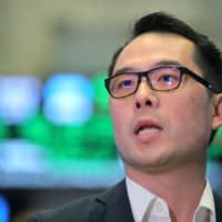 Slack Technologies Inc. CFO Allen Shim stands on the trading floor during the company\'s direct listing at the New York Stock Exchange (NYSE) in New York Thursday. | REUTERS
