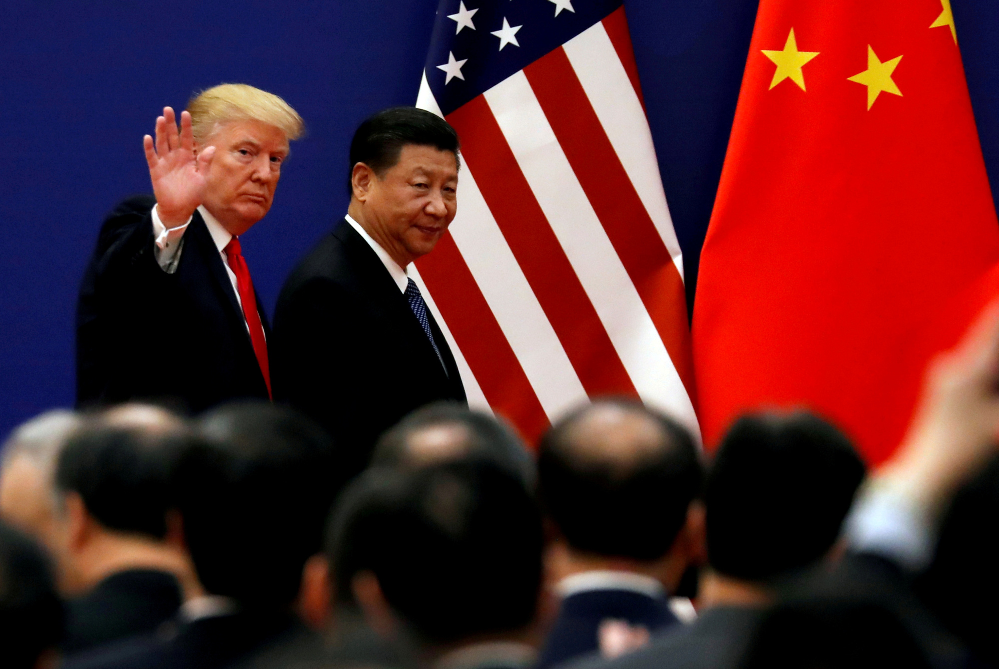 U.S. President Donald Trump and Chinese leader Xi Jinping meet business leaders at the Great Hall of the People in Beijing in November 2017. | REUTERS
