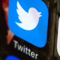 The Twitter app is seen on a mobile phone in Philadelphia in April. Twitter said Thursday it has deleted nearly 4,800 accounts linked to the Iranian government that served to promote state actions without disclosing their political connection. | AP