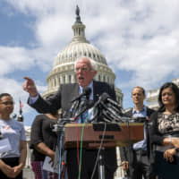 Democratic presidential candidate Sen. Bernie Sanders, I-Vt., flanked by Rep. Ilhan Omar, D-Minn. (left) and Rep. Pramila Jayapal, D-Wash., calls for legislation to cancel all student debt, at the Capitol in Washington Monday. Sanders called the student debt burden in this country the absurdity of sentencing an entire generation, the millennial generation, to a lifetime of debt for the crime of doing the right thing. | AP