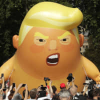 A 6-meter-high cartoon baby blimp of U.S. President Donald Trump is flown as a protest against his visit, in Parliament Square in London last July. Trump\'s long-delayed state visit on Monday, timed to coincide with ceremonies marking the 75th anniversary of the D-Day invasion, has been deeply divisive since Theresay May extended the invitation on behalf of the queen in the first week of Trump\'s administration. | AP