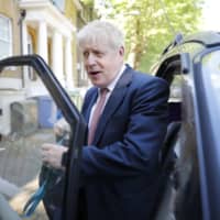 Boris Johnson gets into a car in London on Thursday. | AFP-JIJI