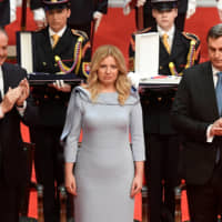 Zuzana Caputova is applauded during her swearing-in ceremony as Slovakia\'s first female head of state in Bratislava on Saturday. | REUTERS