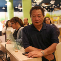 Lin Guo-cing, a senior official of the Chinese Unification Promotion Party, is pictured on April 9 in a shop at a theme park in Chiayi, Taiwan, that he is planning to introduce to the Chinese market. | REUTERS