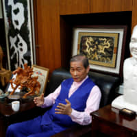 Chinese Unification Promotion Party leader Chang An-lo gives an interview in Taipei on May 2 beside a bust of the late Chinese leader Deng Xiaoping. | REUTERS