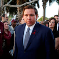 Florida\'s Republican Gov. Ron DeSantis (right) on Friday signed a bill to restore the voting rights of felons who have served their time, with exceptions for those convicted of murder and sexual offenses. | REUTERS