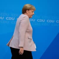 German Chancellor Angela Merkel of Germany\'s conservative CDU party leaves following a short statement on Sunday to comment on the leadership crisis at the CDU\'s coalition partner in the government, the social democratic SPD party. The leader of Merkel\'s junior coalition partner, the SPD, resigned Sunday from her party\'s top jobs, raising the possibility that Germany\'s embattled government could collapse. | AFP-JIJI