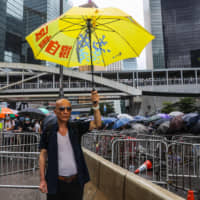 Hong Kong residents protest the proposed extradition law outside the government headquarters on Wednesday, when a show of strength against the government paralyzed the city center. | AFP-JIJI