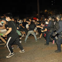Protesters rallying against proposed amendments to the extradition law clash with police at the Legislative Council in  Hong Kong early Monday. | AP