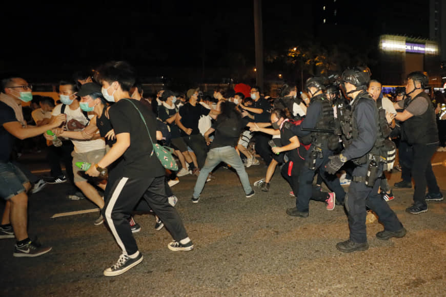 Protesters rallying against proposed amendments to the extradition law clash with police at the Legislative Council in Hong Kong early Monday. | AP