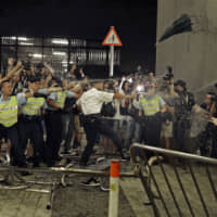 Police officers use pepper spray against protesters during a rally against proposed amendments to the extradition law at the Legislative Council in Hong Kong during the early hours of Monday | AP