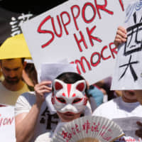 Protesters march in Los Angeles on Sunday during a demonstration to protest against the extradition law proposed by Hong Kong\'s pro-Beijing government. | AFP-JIJI