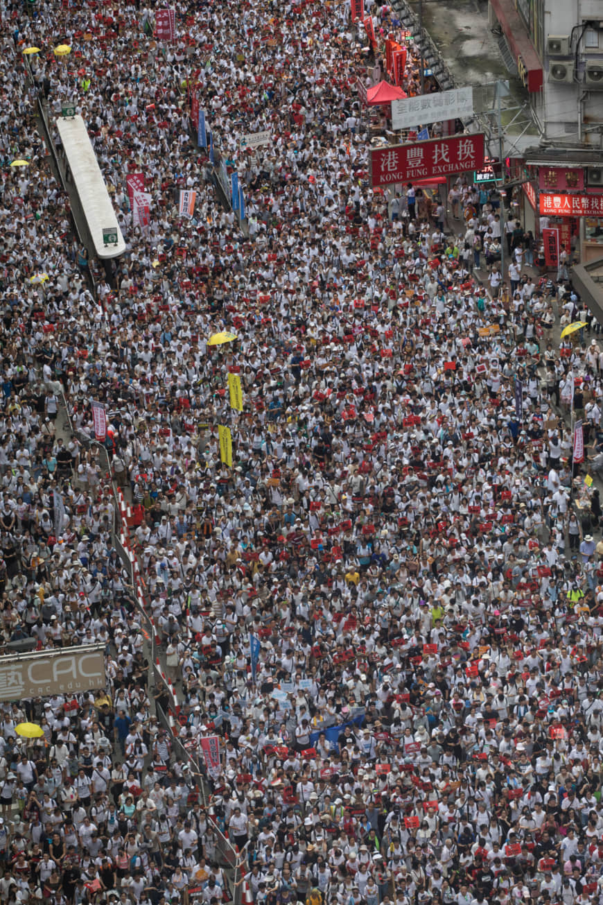 Demonstrators march during a protest against a proposed extradition law in Hong Kong on Sunday. An estimated 1 million people turned out to oppose the measure. | BLOOMBERG